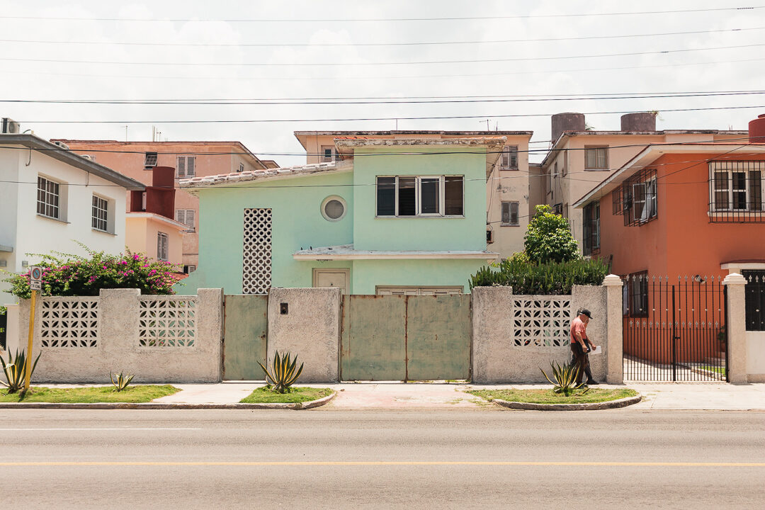 Pastel-coloured houses along a street in Havana