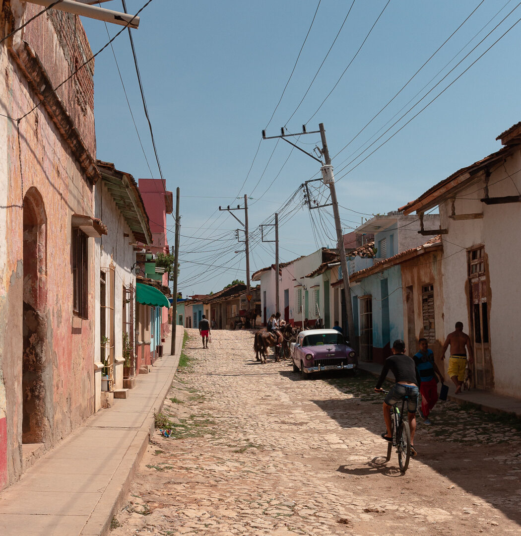 A cobblestone street in Trinidad, Cuba, lined with colourful buildings